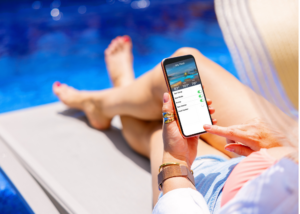 a woman using an app on her phone to control her pool and spa